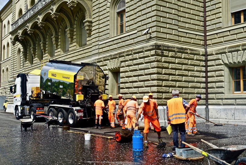 building exterior, group of people, men, day, water, architecture, working, street, rain, occupation, 4K, construction, asphalt, workers, mode of transportation