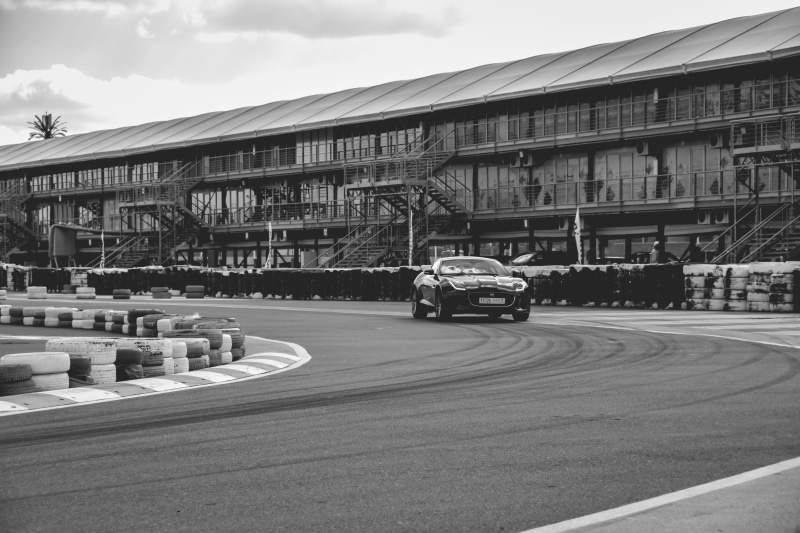 vehicle, wheel, street, land vehicle, jaguar f type, formula one, no people, tarmac, mode of transportation, nature, road, building exterior, transportation