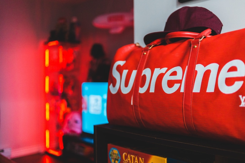 text, sale, business, red, for sale, duffel, supreme, bag, logo, people, retail, letter, bar counter, beverage, coke, still life, consumerism, soda, food