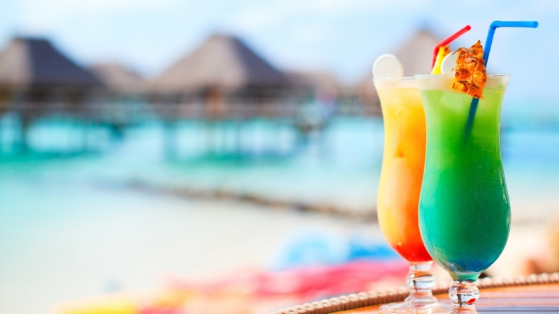 straw, cocktails, swimming pool, two, refreshment, cocktail, tropical drink, drink, fruit, no people, focus on foreground, glass, multi colored, drinking glass