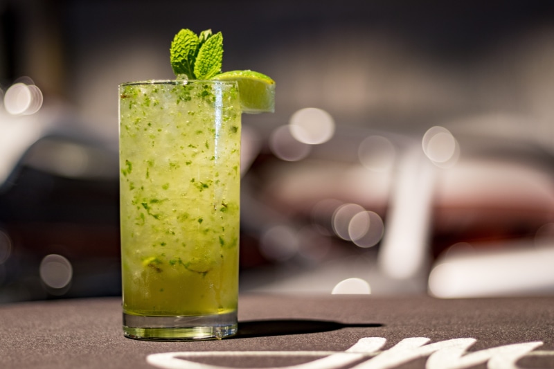 drinking glass, lime, alcoholic, still life, indoors, table, mojito, recipe, no people, bar counter, ingredient, healthy eating, tropical, herb, freshness