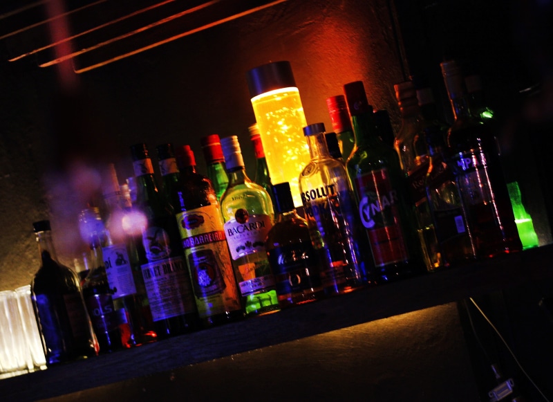 glass, container, nightlife, illuminated, alcoholic, bottles, city, building exterior, lamp, pub, office building exterior, liquor, refreshment, cocktail