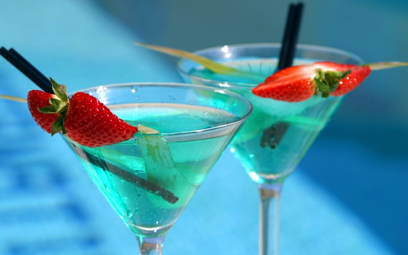 focus on foreground, cocktail, berry fruit, alcohol, martini glass, food and drink, household equipment, herb, healthy eating, drinking straw, close-up