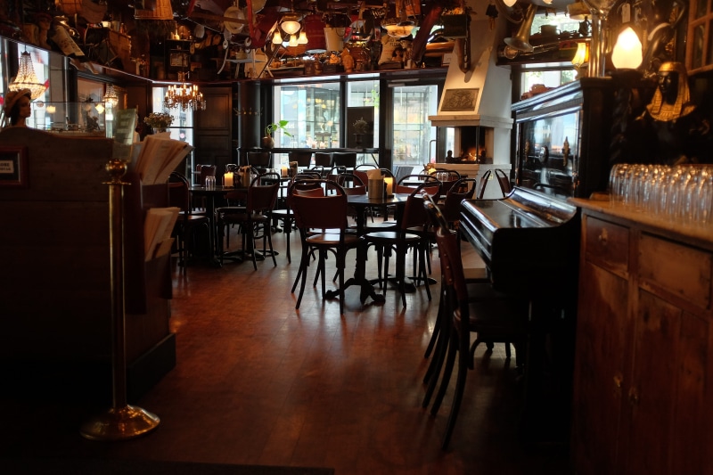 nightlife, piano, business, cafeteria, furniture, chair, wine bottle, bar counter, pub, illuminated, food, no people, human, electric lamp, person, cafe