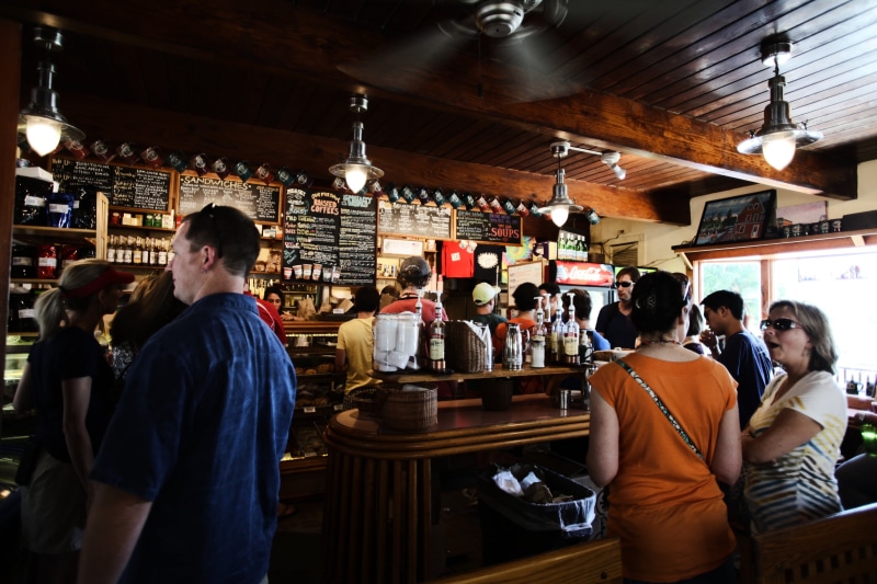 signs, pub, standing, lighting equipment, woman, indoors, coffee shop, group, menus, cafe, crowd, 4K, business, women, leisure activity, adult, nightlife
