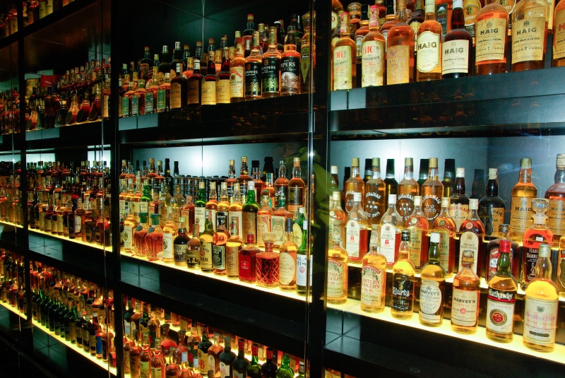 assorted, in a row, shelf, variation, large group of objects, for sale, container, collection, food, whisky, indoors, wine, bar counter, bottle, arrangement