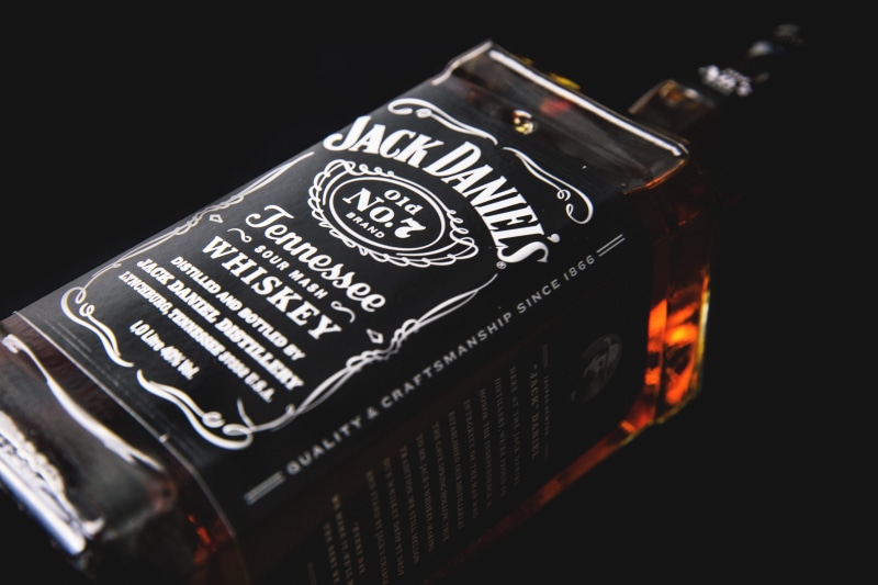 text, black color, luxury, s, alcohol, camera - photographic equipment, wealth, photographic equipment, modern, black background, blur, no people, indoors