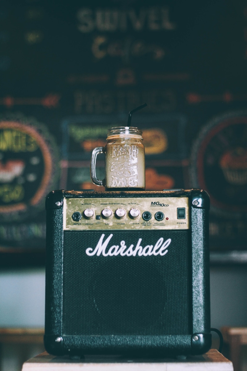 western script, indoors, sign, jar, marshall, close-up, beverage, glass mug, top, handle, icedcoffee, amplifier, 2K, information, focus on foreground