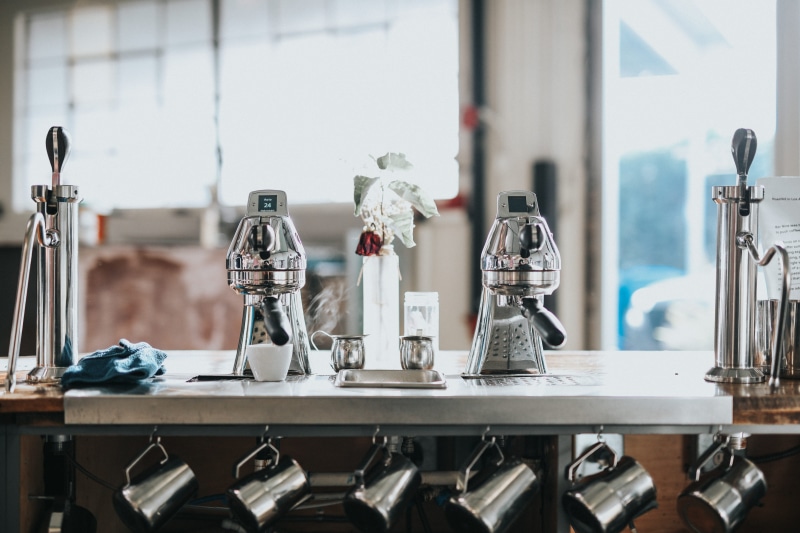 household equipment, preparation, cafe, makers, indoors, juicer, coffee shop, table, glass - material, gray, machine, no people, two, steel, transparent