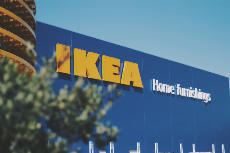 text, finance, architecture, symbol, blue, store, ikea, low angle view, outdoors, nature, clear sky, built structure, sky, guidance, building, day, no people