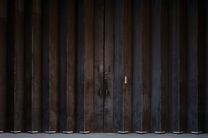 garage, corrugated iron, rusty, safety, closed, wood - material, street, pattern, brown, wall - building feature, boundary, no people, accordion, outdoors