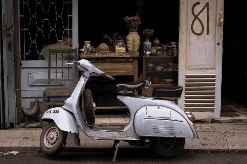 motor bike, vintage, motor scooter, building exterior, day, parking, no people, outdoors, built structure, beside, small, house, coffee shop, entrance