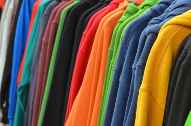 lot, garment, casual clothing, rack, business, multi Colored, sweatshirts, in a row, order, no people, shelves, large group of objects, hanging, color