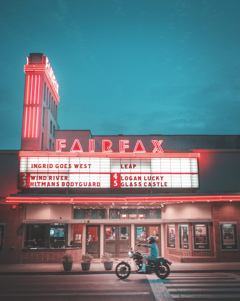 cinema, public transportation, car, building exterior, motorbike, 4K, outdoors, neon, business, theater, western script, real people, fair, sign, communication