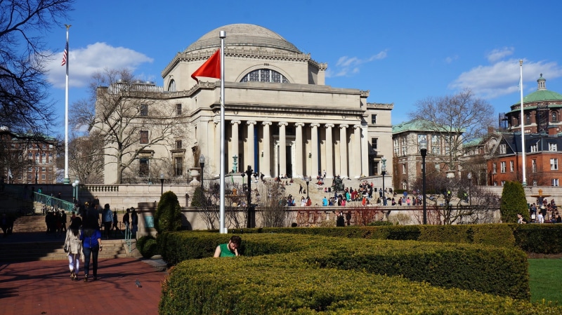 built structure, politics, group of people, brown, government, facade, columbia university, outdoors, building, architecture, flag, cloud - sky, architectural column