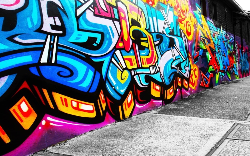 day, footpath, text, creativity, street, wall, no people, built structure, art and craft, wall - building feature, yellow, architecture, city, western script