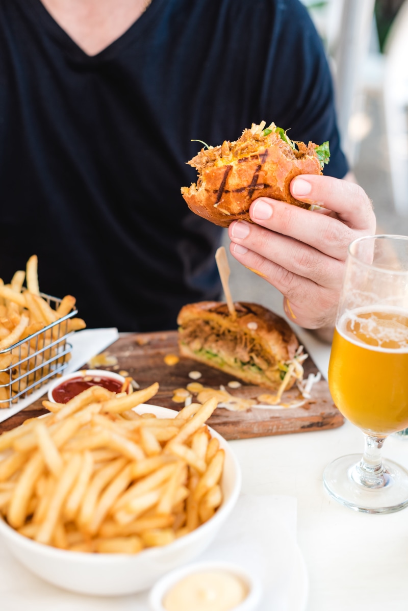 fried, beer, refreshment, midsection, food, table, freshness, glass, food and drink, burger, temptation, hamburger, fruit, 5K, holding, potato, sandwich