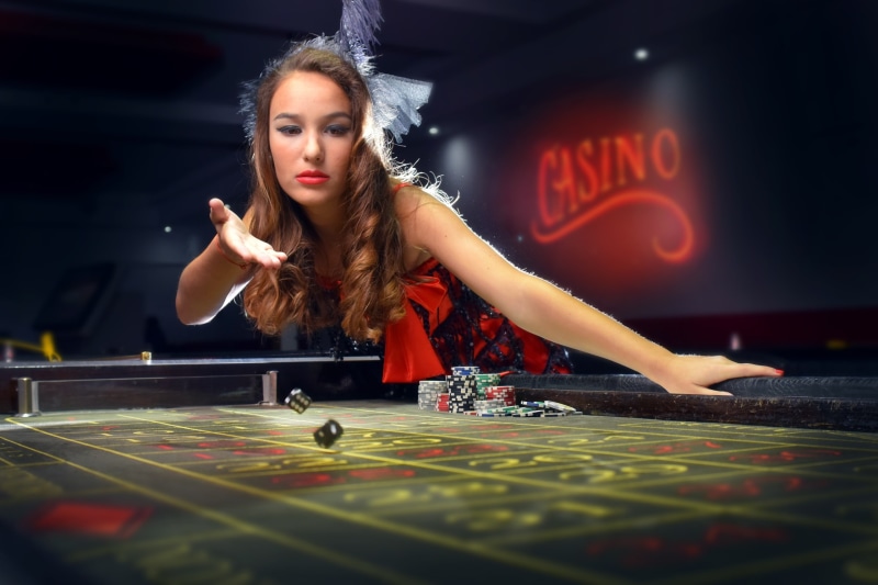 leisure games, gambling, leisure activity, table, beautiful woman, young adult, night, playing, arts culture and entertainment, relaxation, dice, indoors