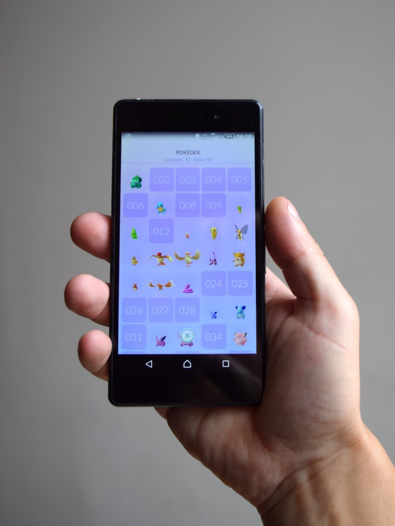 one person, technology, finger, screen, portable information device, holding, game, phone, device screen, studio shot, telephone, augmented, indoors, smartphone