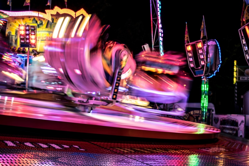 long exposure, crowd, blurred motion, building, illuminated, leisure games, carousel, amusement park ride, rollercoaster, leisure activity, amusement park