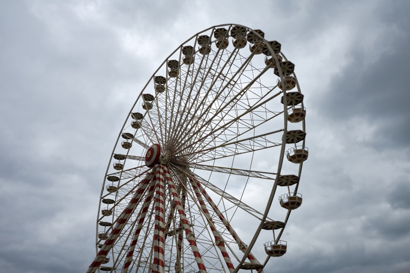 leisure activity, turned, manege, ferris wheel, architecture, no people, cloud - sky, gray, fairground, built structure, enjoy, geometric shape, circle
