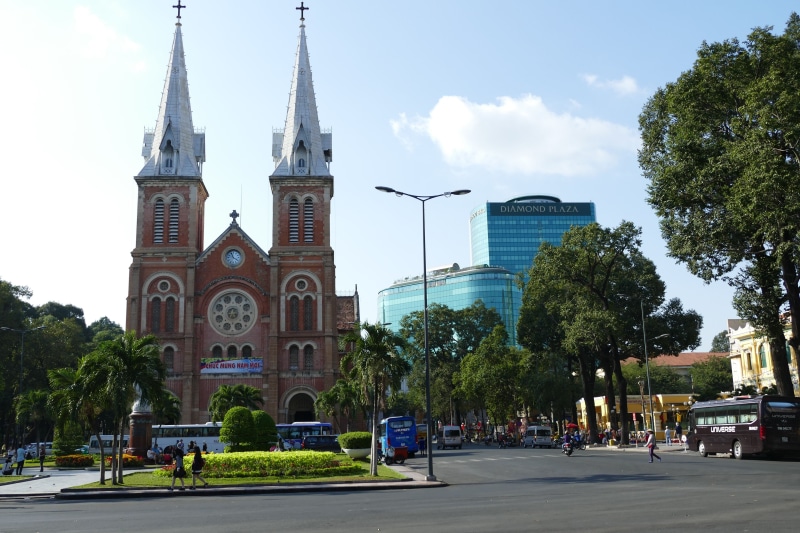 belief, architecture, car, tree, mode of transportation, built structure, nature, spire, building exterior, tower, catholic, religion, ho-chi-minh-city