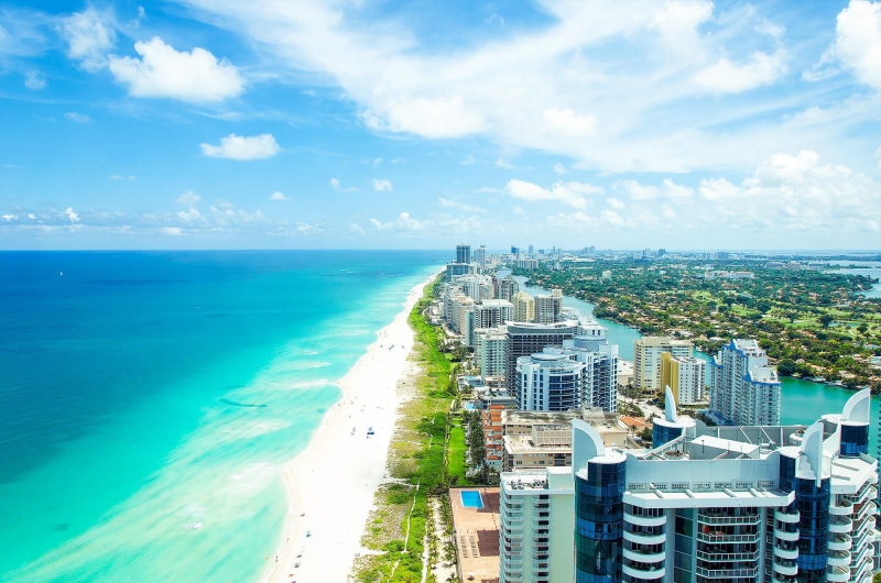 tropical Climate, coastline, no people, skyscraper, sky, water, blue, building Exterior, aerial View, panoramic, high angle view, famous Place, sand, tourist