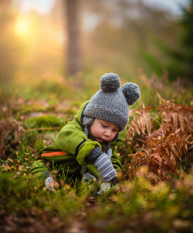 season, full length, smiling, ground, clothing, one Person, lifestyles, outdoors, joy, knit hat, caucasian Ethnicity, casual clothing, fun, park - Man Made Space