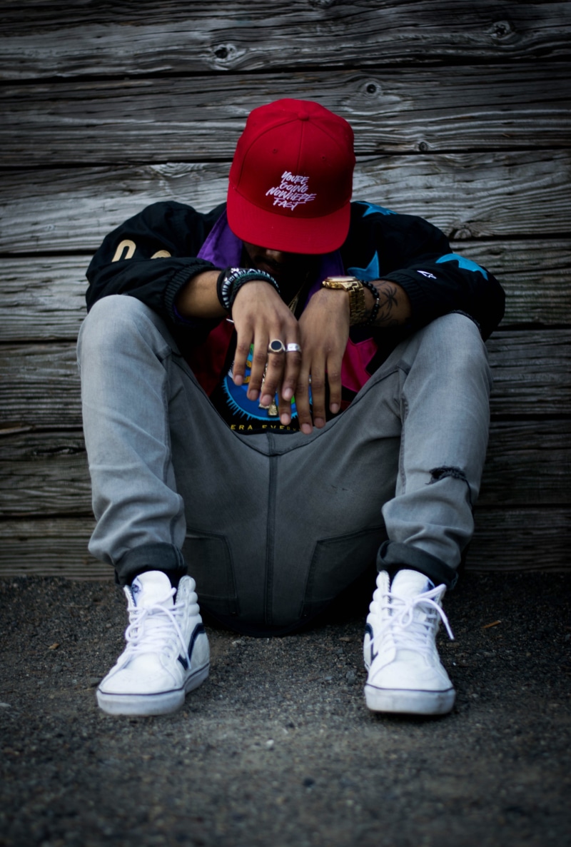 man, full length, male, sitting, low, cap, hat, white, top, mood, real people, casual clothing, positive emotion, sneaker, obscured face, leisure activity