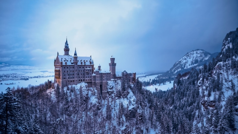 cloud, wintertime, outdoors, alps, place of worship, plant, cold temperature, landmark, tree, tourist attraction, neuschwanstein castle, building, nature