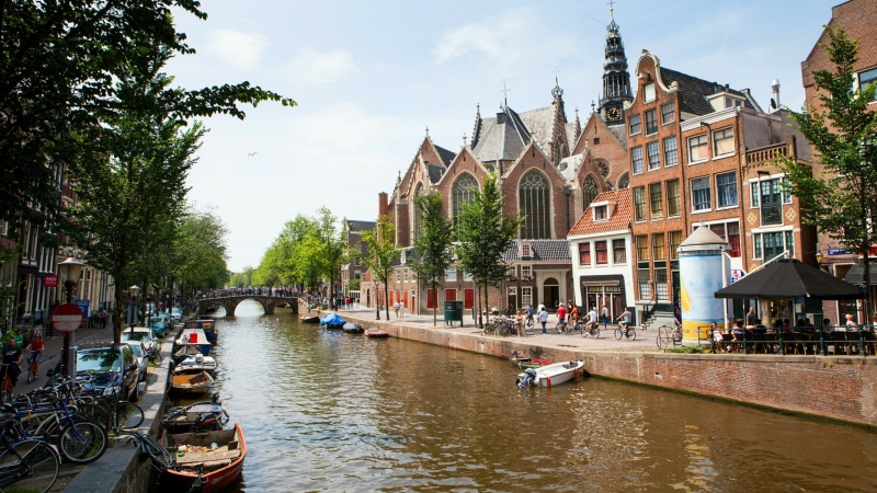 travel destinations, building exterior, boats, canal, waterfront, incidental people, netherlands, old church, built structure, architecture, europe, building