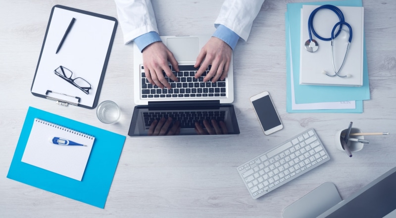 Phone, Hospital, computer keyboard, hand, Desk, Laptop, Keyboard, working, using laptop, one person, table, magic, computer monitor, Computer, technology