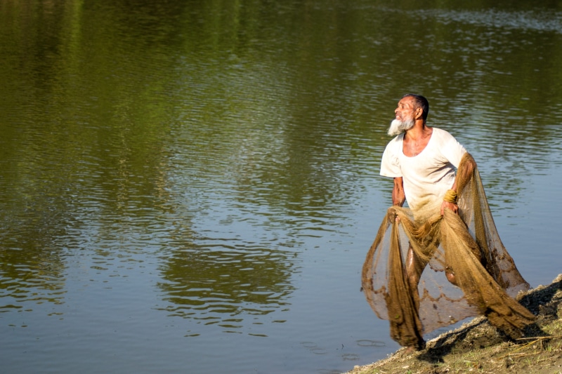 bangladesh, sitting, leisure activity, shorts, aim, full length, rural, nature, noakhali, men, village, plant, casual clothing, real people, lake, fisherman