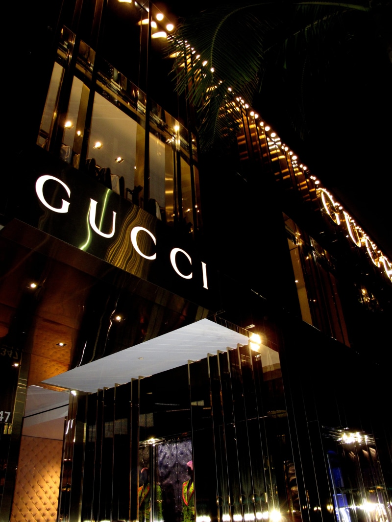 transparent, street light, gucci, glass - material, architecture, text, lighting equipment, built structure, building exterior, outdoors, city, reflection