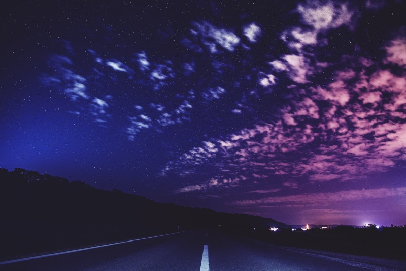 diminishing perspective, sign, tree, concrete, transportation, galaxy, star - space, direction, dark, country road, black, outdoors, sky, astronomy, landscape