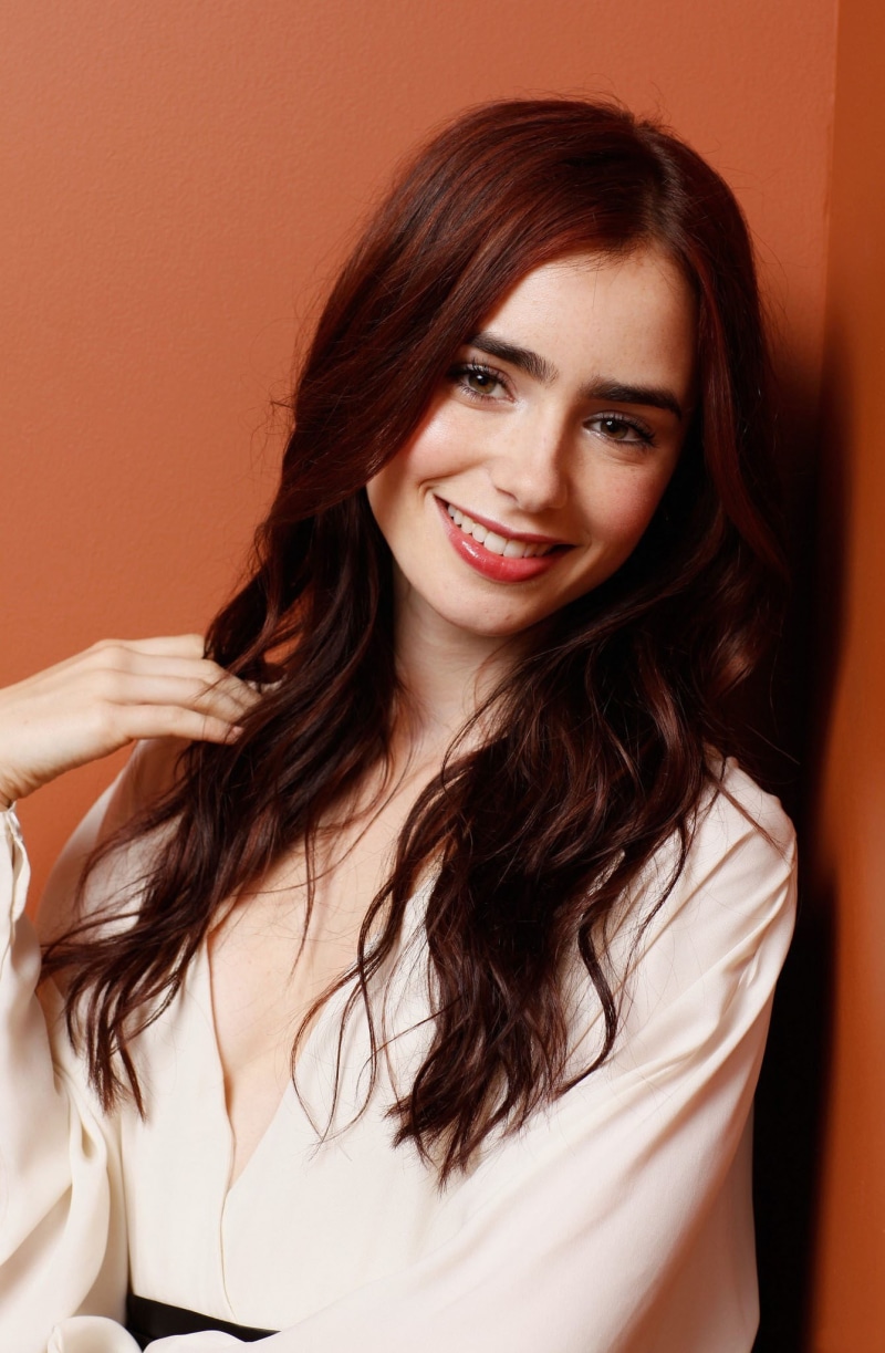cheerful, looking at camera, adult, top, cleavage, beautiful woman, portrait, brown eyes, hair, emotion, hairstyle, sleeved, young adult, touching hair