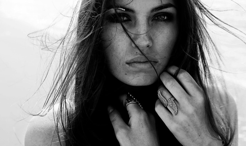human face, human hair, headshot, lifestyles, ring, hand, one person, beautiful woman, hairstyle, real people, front view, close-up, monochrome, rings