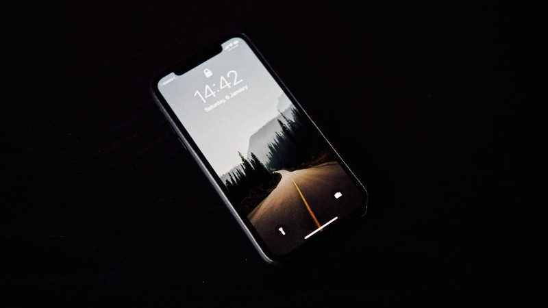 black background, sign, studio shot, black color, technology, wireless technology, western script, smart phone, mobile phone, turned, single object, crime