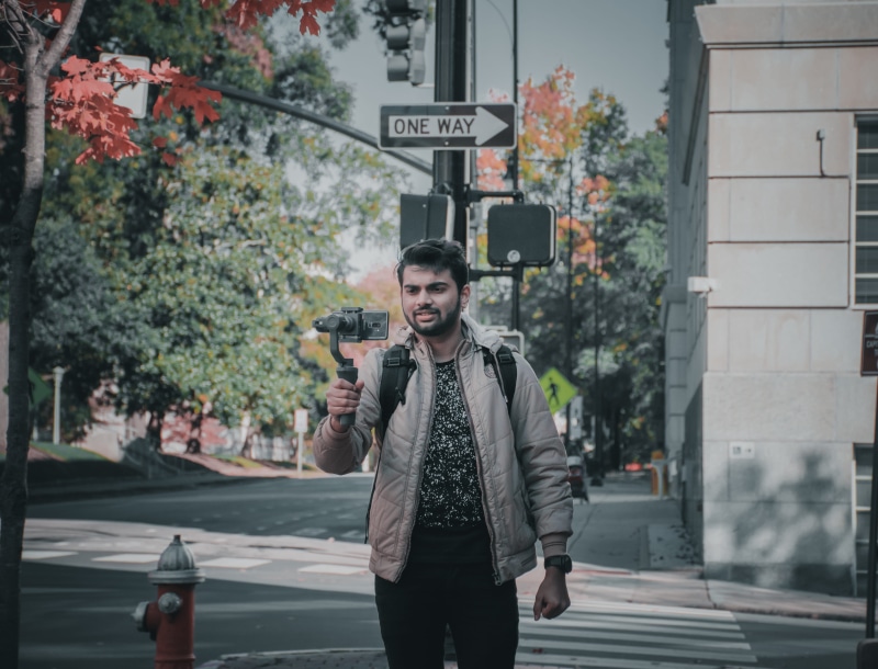 architecture, real people, s9plus, jacket, young adult, photography, street, communication, sign, casual clothing, mobile, handsome man, leisure activity