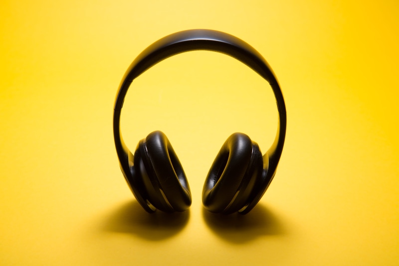 cut out, two objects, level, jewelry, close-up, studio shot, yellow background, wireless, ear defender, gold colored, no people, black, wealth, colorful