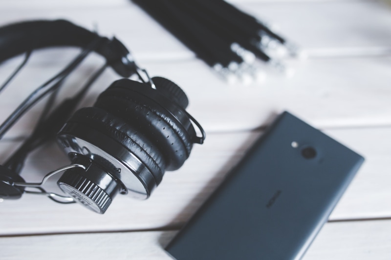 photography themes, black, smart phone, music, equipment, indoors, headphones, tech, analog, single object, digital camera, lens - optical instrument, communication