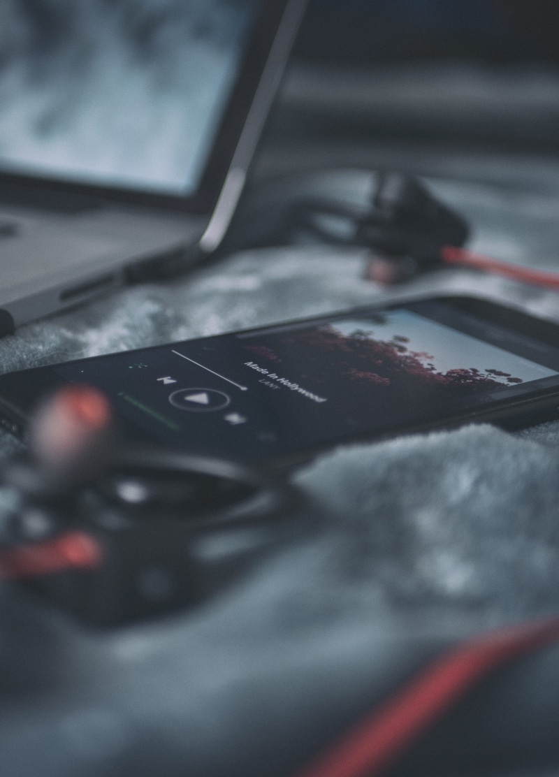 indoors, beside, textile, smartphone, dark, red, app, mode of transportation, computer, technology, vehicle interior, music, cold tones, wireless technology