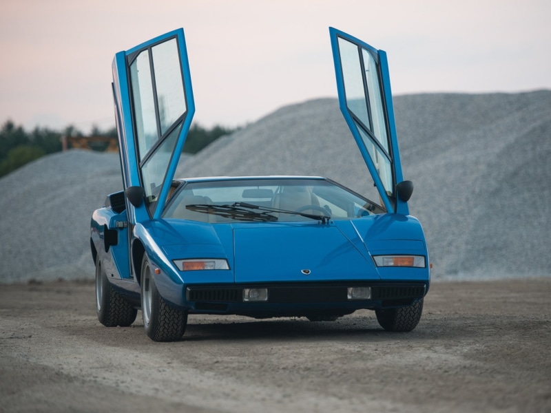 Lamborghini Countach, car, communication, sky, blue, on the move, motor vehicle, land, road trip, land vehicle, no people, road, mode of transportation
