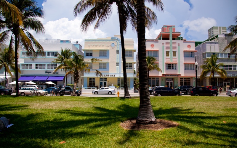 transportation, outdoors, sky, tropical climate, hotels, South Beach, built structure, car, cars, tree, architecture, palm trees, vice city, day, mode of transportation