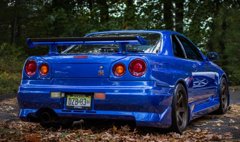 vintage car, headlight, day, mode of transportation, transportation, no people, nature, land, outdoors, blue, car, stationary, retro styled, plant, Nissan Skyline GT-R R34