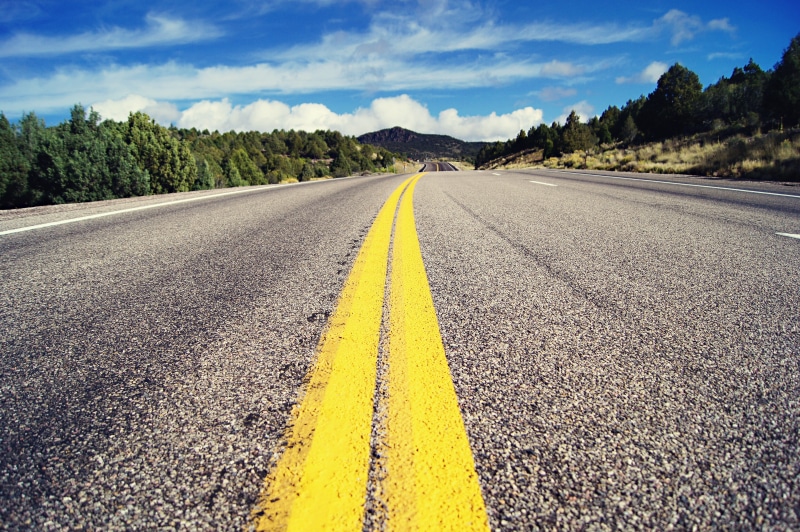 marking, double yellow line, outdoors, dirt road, yellow, diminishing perspective, asphalt, surface level, tar, tarmac, sign, road, plant, route, symbol