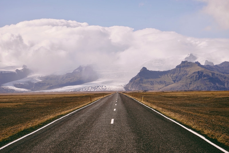 sky, direction, sign, outdoors, transportation, mountain, plant, tarmac, on, dividing line, highway, beauty in nature, daytime, range, travel, the way forward