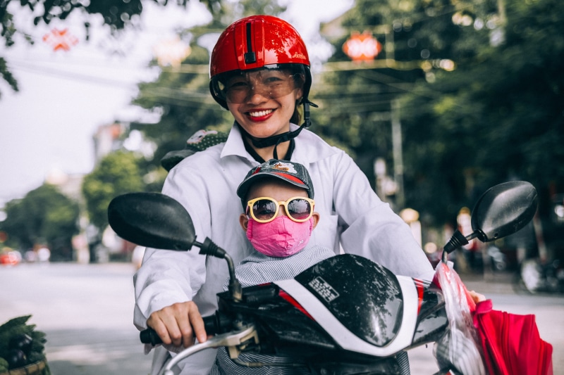 sports helmet, headwear, cheerful, 2K, transportation, portrait, mask, baby, boy, one person, kid, mother, emotion, son, motorcycle, happiness, outdoors