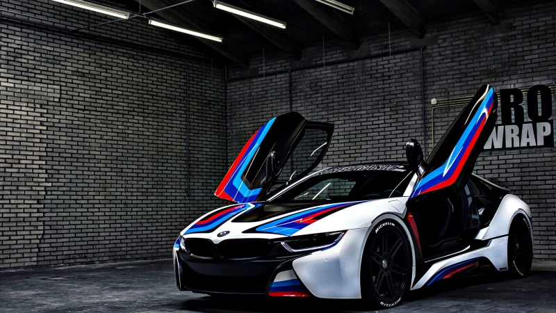 indoors, wall - building feature, wheel, mode of transportation, built structure, automotive exterior, transportation, vehicle, bmw, motor vehicle, stationary