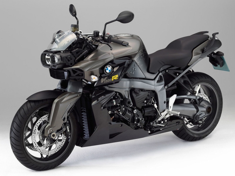 white background, kr, no people, wall - building feature, engine, sports, transportation, wheel, helmet, motorcycle, metal, riding, stationary, gray, leather